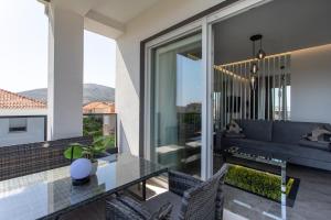 a living room with a glass table and a couch at Apartments Taratta in Trogir