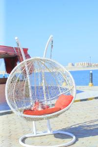 a bird cage sitting on a pier next to the water at The View Aqua Park in Marsa Matruh
