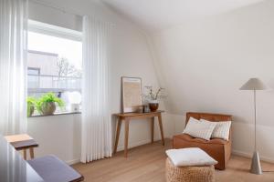 a living room with a chair and a window at The Oak - Ekerum Öland in Borgholm +85 photos