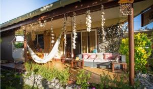 a porch with a hammock on a house at Chez Pilar in Avatoru