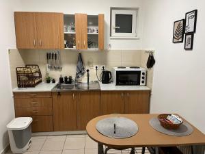 a small kitchen with a table and a microwave at Jelena in Novi Sad