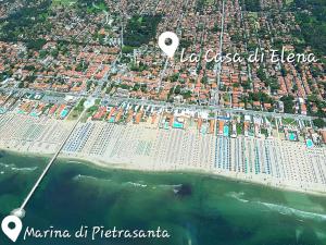 an aerial view of a beach with buildings and the ocean at La casa di Elena Versilia - Two Apartments in Marina di Pietrasanta