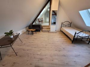 a room with a bed and chairs and a staircase at Loft Apartment am Bahnhof in Albstadt +2 photos