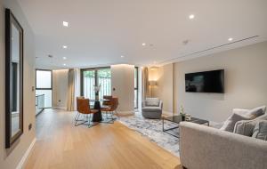 a living room with a couch and a table at Arcadia Residences - Luxury Apartments in Kensington, London in London