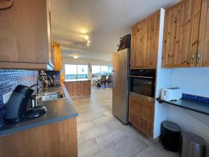 a kitchen with a sink and a refrigerator at House in Akranes - Birta Rentals in Akranes