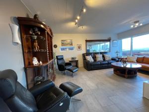 a living room with a couch and a table at House in Akranes - Birta Rentals in Akranes