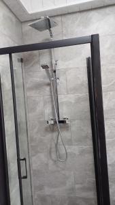a shower in a bathroom with a glass door at Budgeted Residence near Coventry Building Society (CBS) Arena with Parking in Exhall