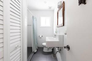 a white bathroom with a sink and a toilet at 3BR Rebecca Lakehouse with Fireplace Wifi and Dock in Oxtongue Lake +37 photos