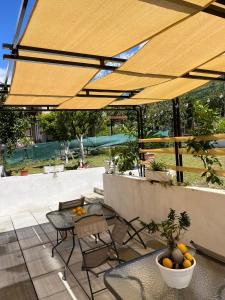 a patio with a table and chairs under a yellow umbrella at Casa Consiglia in Corbara