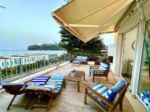 a patio with chairs and tables and a view of the ocean at Il Profumo del Mare in Cagliari