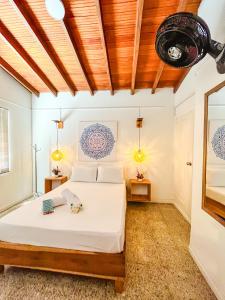 a bedroom with a bed and two tables at Hostal Casa Guadalupe in Medellín