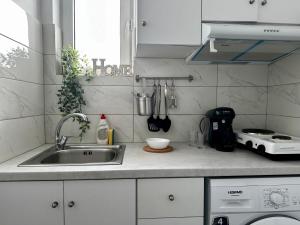 a kitchen counter with a sink and a stove at Modern Apartment in Kos Town, Walking Distance to the Beach - No 4 in Kos Town +11 photos