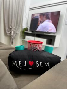 a new bum pillow on a couch in a living room at Cantinho de paz in Santarém