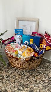 a basket of food and snacks on a counter at Cantinho de paz in Santarém