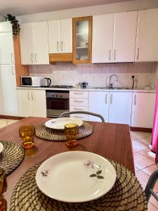 a kitchen with a wooden table with plates on it at Lucia home Vicenza in Vicenza