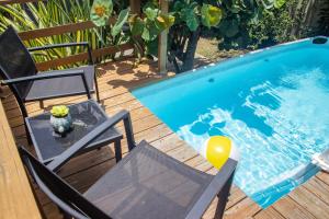 a table and chairs next to a swimming pool at 212 APARTMENT in Rincon