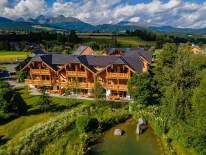an aerial view of a large log home with a river at AlmApARTment Mauterndorf Pichl 9-3 in Mauterndorf