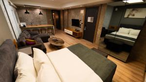 a living room with a couch and a bed in a room at Mas Suites Nisantasi in Istanbul