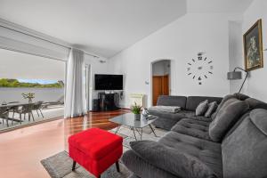 uma sala de estar com um sofá e um banco vermelho em Villa 50 Shades of Grey em Pula
