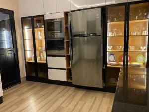 a kitchen with two large refrigerators in a room at Dar Fatouma - Tazarka in Tazarka
