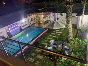 an overhead view of a swimming pool with an umbrella at Dar Fatouma - Tazarka in Tazarka