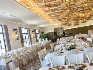 a banquet hall with white tables and white chairs at Hotel Finca las Beatas in Villahermosa +67 photos