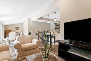 a living room with a large flat screen tv at Perfection near the River - 4 Bedroom Villa Complimentary Breakfast Delivered Daily to the Rental in Niagara Falls