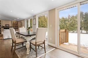 a dining room with a table and chairs at Perfection near the River - 4 Bedroom Villa Complimentary Breakfast Delivered Daily to the Rental in Niagara Falls
