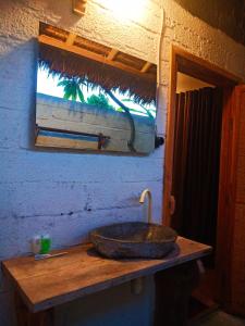 a bathroom with a stone sink and a window at Umah Kayu 1-Menjangan homestay in Banyuwedang +149 photos