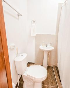 a bathroom with a toilet and a sink at Hotel Villa Santa María in Santa Fe de Antioquia