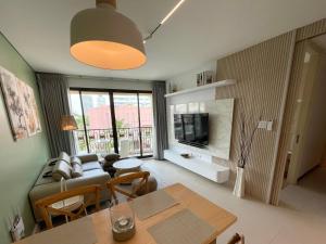 a living room with a couch and a table at Marrakesh Residence 325 in Hua Hin