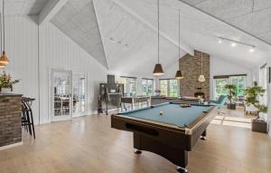 a living room with a pool table in it at Amazing Home In Blåvand With Sauna in Blåvand