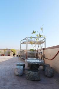 a park with a bench and a table and some rocks at Lefu B&B in Dongshan