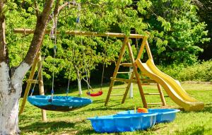 a playground with two swings and a swing at Amazing Home In Donja Lomnica With Kitchen in Donja Lomnica