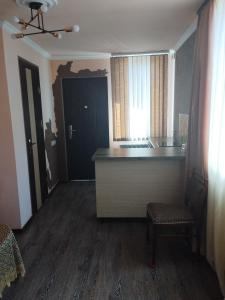 a kitchen with a counter and a chair in a room at Dava in Gyumri