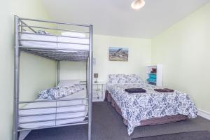a bedroom with a bunk bed and a bunk ladder at Braemar House B&B and YHA Hostel in Whanganui