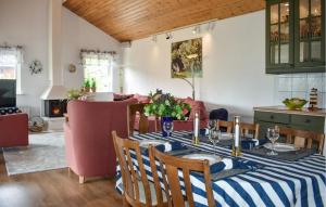 a kitchen and dining room with a table and chairs at Nice Home In Beddingestrand in Beddinge Strand
