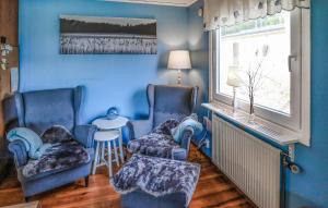 a blue room with two chairs and a window at Amazing Home In Ätran With Kitchen in Ätran