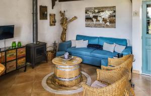 a living room with a blue couch and a wood stove at Nice Home In Escales With House A Panoramic View in Escales
