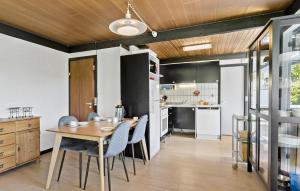 a kitchen and dining room with a table and chairs at Amazing Home In Svendborg With Kitchen in Vemmenæs