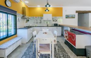 a kitchen with a white table and chairs in it at Nice Home In La Puebla De Los Infan in La Puebla de los Infantes