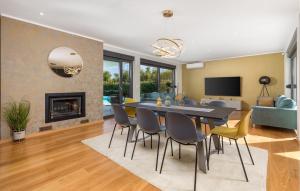 a dining room and living room with a table and chairs at Villa Hedone Rakalj in Krasa