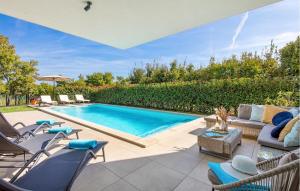 a swimming pool in a backyard with chairs and a couch at Villa Hedone Rakalj in Krasa