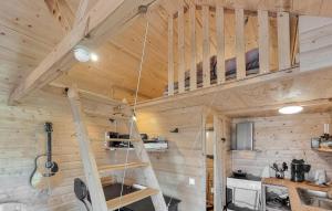 a wooden cabin with a ladder in a kitchen at Stunning Home In Mellerud With Wifi in Brålanda