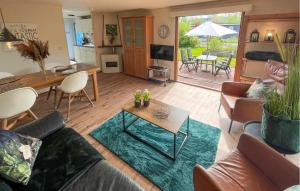 a living room with a couch and a table at Pet Friendly Stacaravan In Tzummarum in Tzummarum