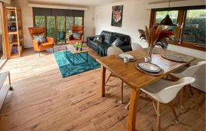 a living room with a table and a couch at Pet Friendly Stacaravan In Tzummarum in Tzummarum