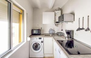 a kitchen with a washing machine and a sink at 2 Bedroom Nice Apartment In Puerto Real in Puerto Real