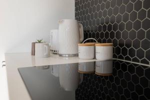 a shelf with pots and pans on a wall at Amazing 4 rooms House near SpringField Lakes in Greenbank