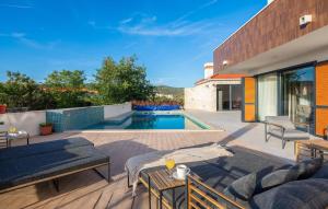 a backyard with a swimming pool and a house at Lovely Apartment In Rogoznica With Wifi in Rogoznica