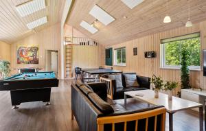a living room with a pool table and ping pong ball at Holiday Home Tværvænget Blåvand in Ho